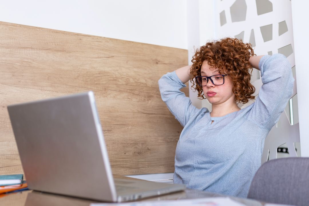 Confused businesswoman annoyed by online problem, spam email or fake internet news looking at laptop, female office worker feeling shocked about stuck computer, bewildered by scam message or virus