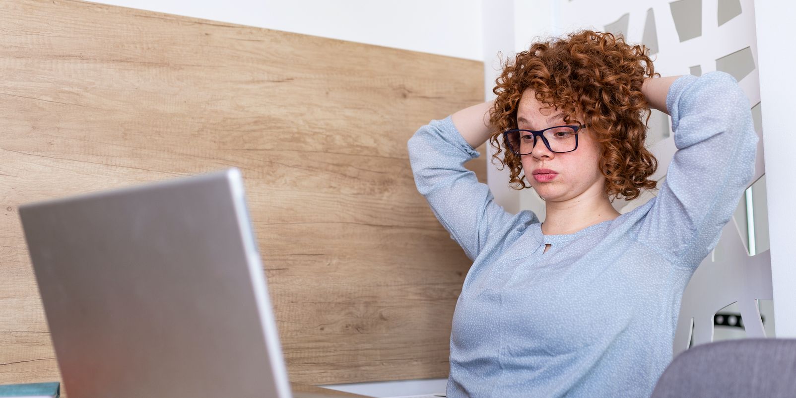 Confused businesswoman annoyed by online problem, spam email or fake internet news looking at laptop, female office worker feeling shocked about stuck computer, bewildered by scam message or virus