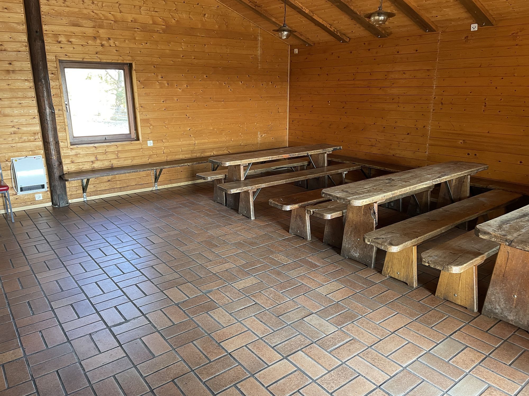 Innenaufnahme der Grillhütte. Zu sehen sind Bänke.