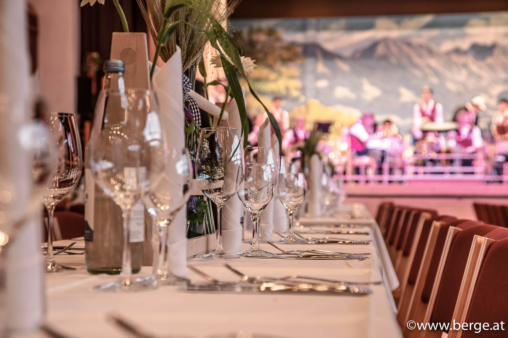 Festlich gedeckter Hochzeitstisch mit eleganter Dekoration, im Hintergrund spielt eine Live-Band – romantische Atmosphäre für einen unvergesslichen Hochzeitstag.