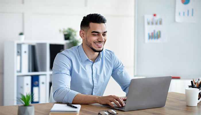 Ein Mann sitzt am Laptop und nutzt die Panelsoftware zur Erstellung von Online-Panels.