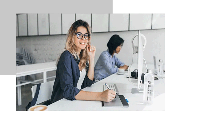A woman is sitting at her desk in the office and taking part in a survey on equality.