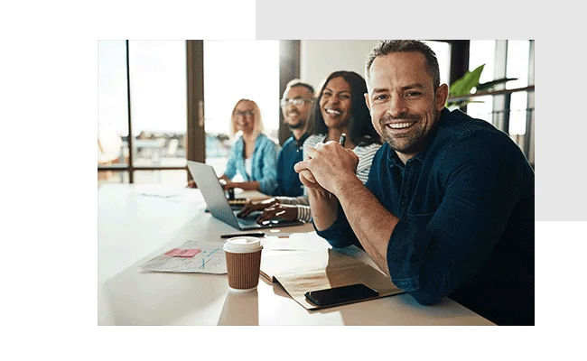 Four employees are visibly happy after the successful implementation of a pulse check.