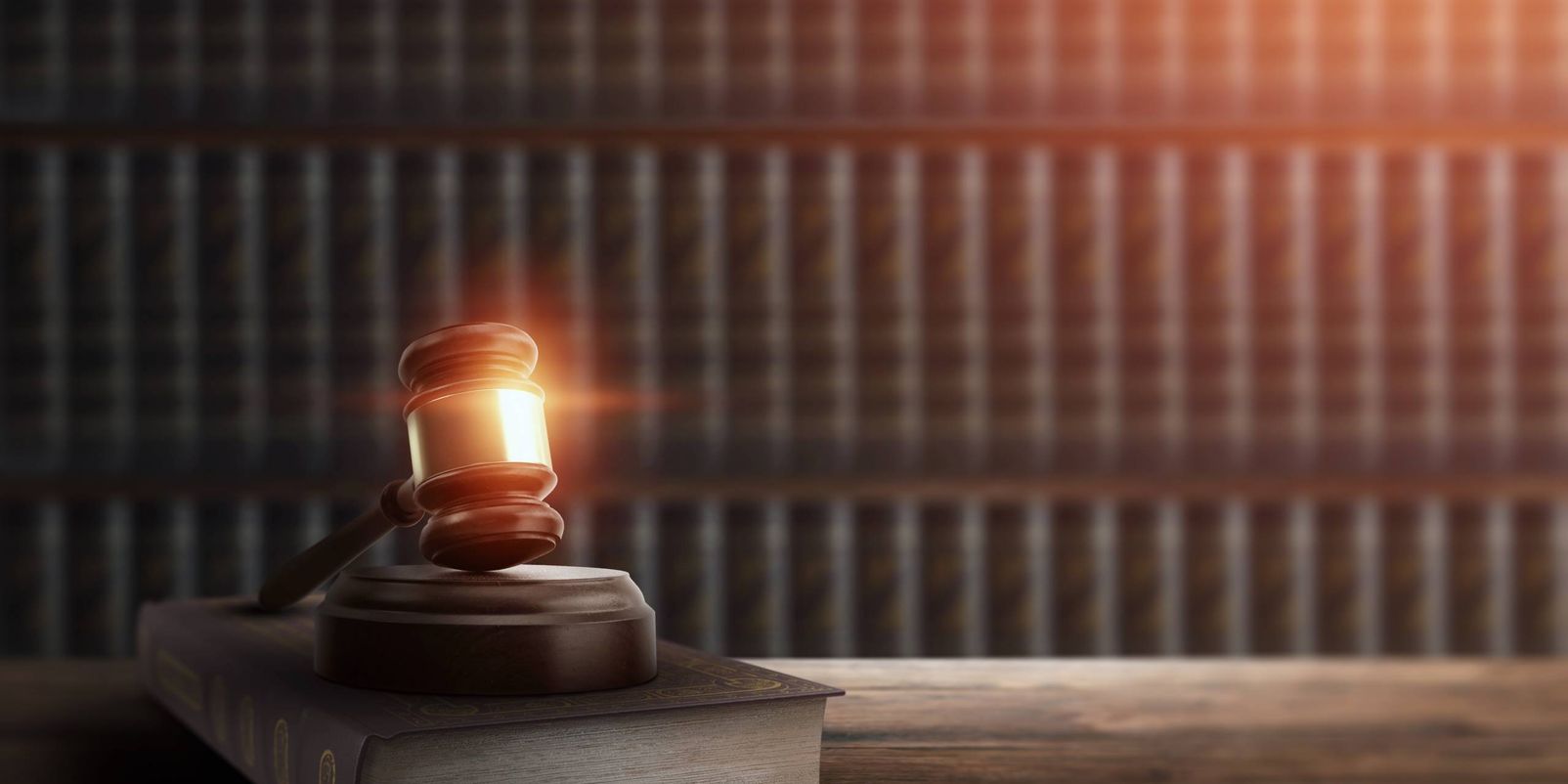 Judge's gavel and a book on a wooden table. Concept of law, justice, punishment, judge, corrupt court. copy space