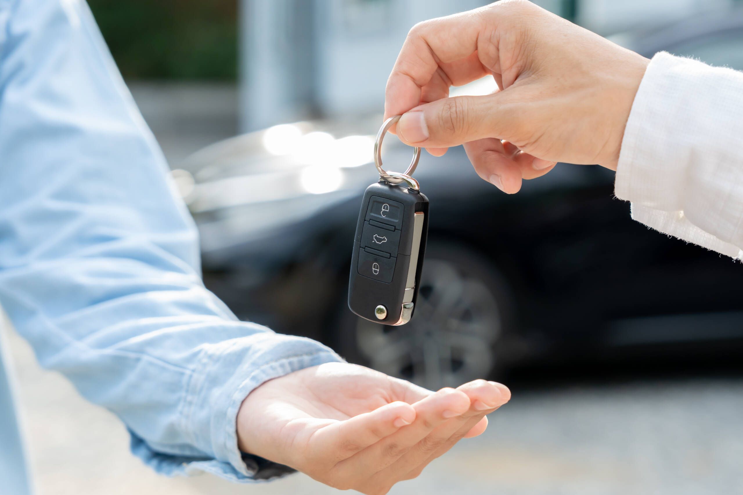 Handing over the keys at a rental car agency