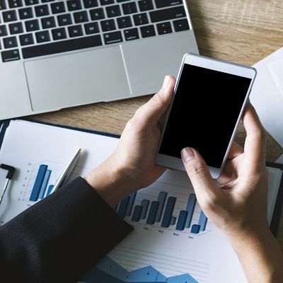 Eine Frau liest den MobileScore an ihrem Handy ab.