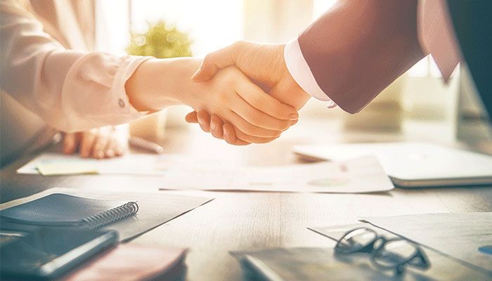 Im Büro geben sich Geschäftspartner die Hand