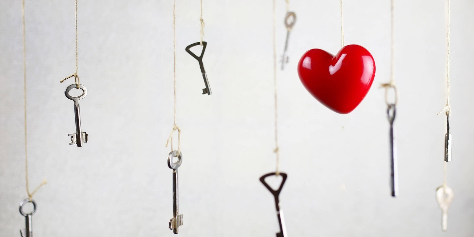 hand stretching for one of the many old vintage keys hanging on threads