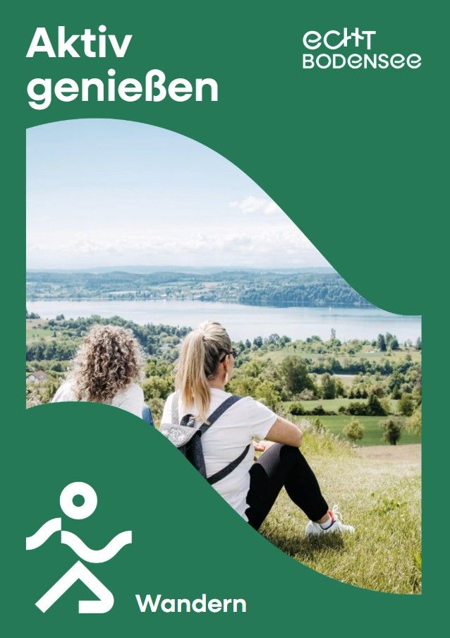 Zwei Frauen sitzen auf einer Wiese und genießen die Aussicht