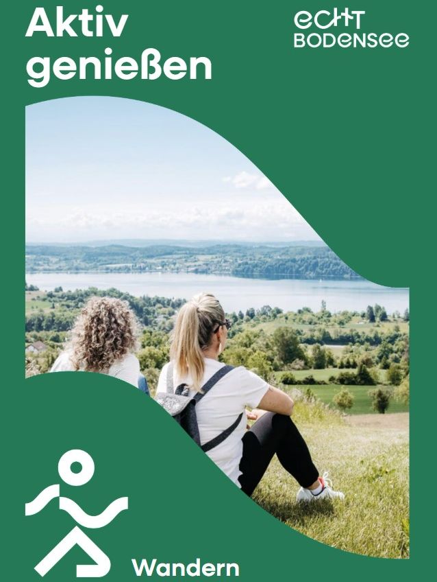 Zwei Frauen sitzen auf einer Wiese und genießen die Aussicht