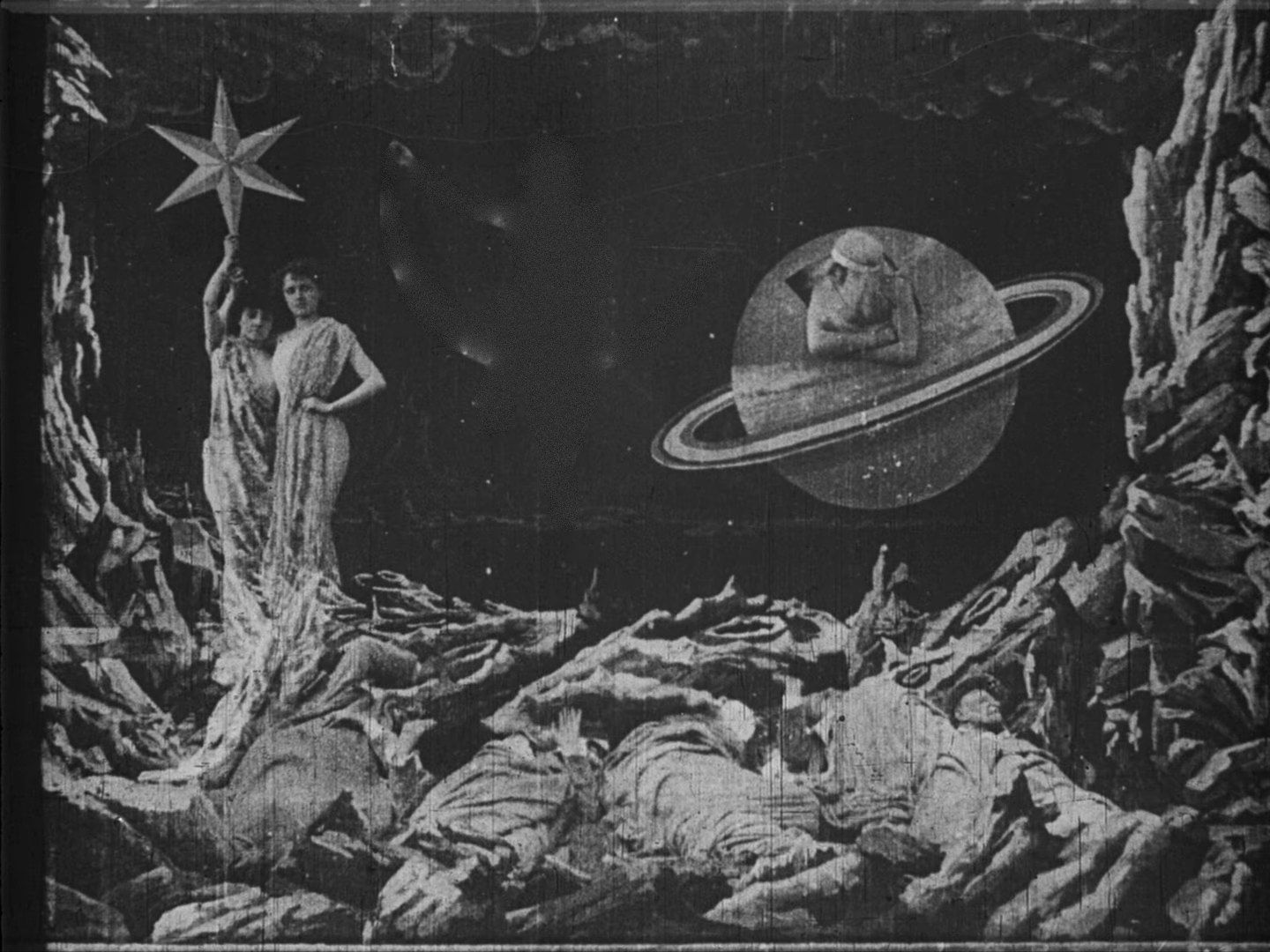 Scene from Georges Méliès’ “A Trip to the Moon”: above the sleeping explorers, Phoebe sits on the crescent moon, beside her Saturn and a woman holding a star.