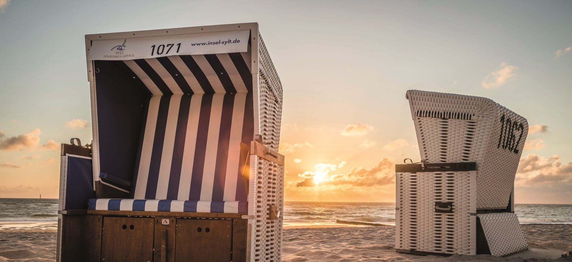 blau-weiß gestreifter Strandkorb am Westerländer oder Rantumer Strand bei Sonnenuntergang